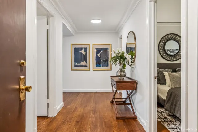 a view of a hallway with wooden floor and entryway