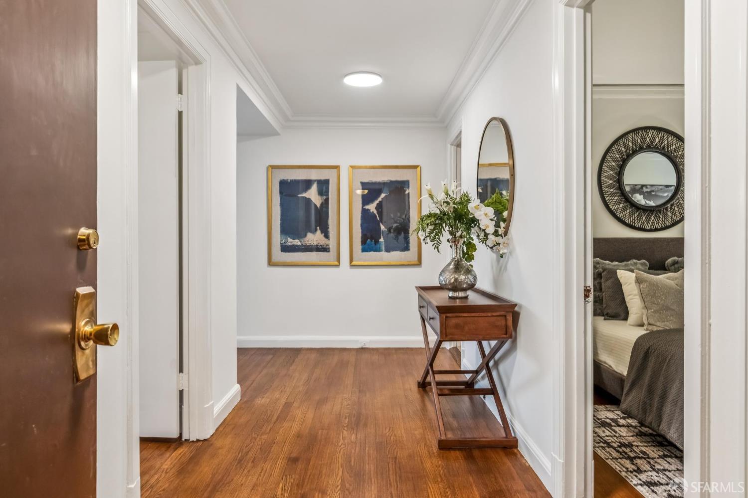 850 Powell Street, Unit 202 San Francisco, CA 94108 - Photo 7 of 51 a view of a hallway with wooden floor and entryway