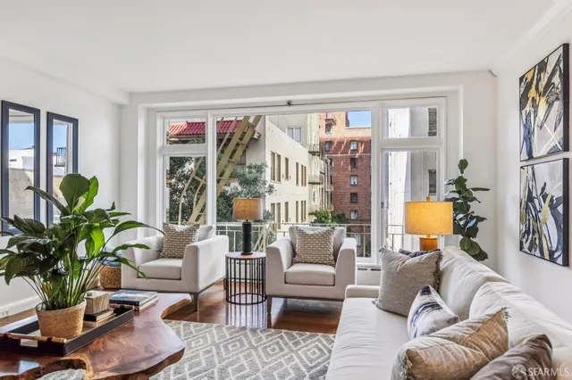 a living room with furniture potted plant and a window