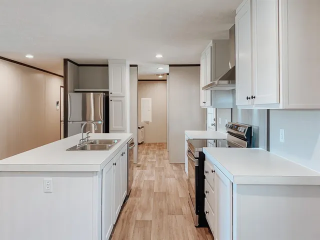 a kitchen with a sink stove and refrigerator
