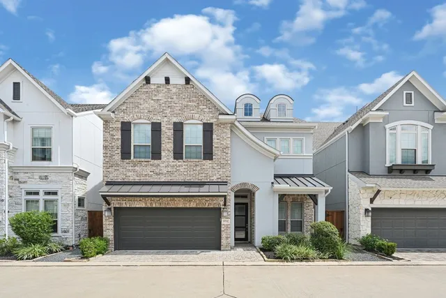 a view of multiple houses with a street