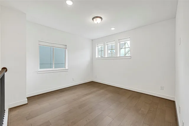 an empty room with windows and closet