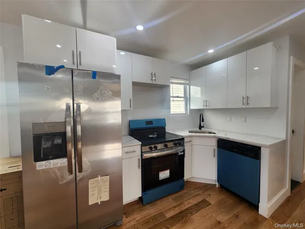 a kitchen with stainless steel appliances granite countertop a stove a refrigerator and a sink