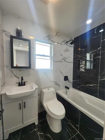 a bathroom with a sink toilet a mirror and shower