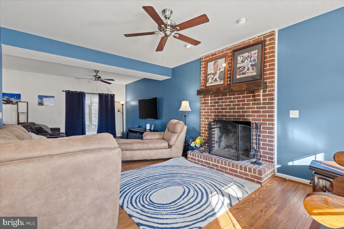 9448 Old Solomons Island Road Owings, MD 20736 - Photo 12 of 49 Family room with fireplace and hard wood floors