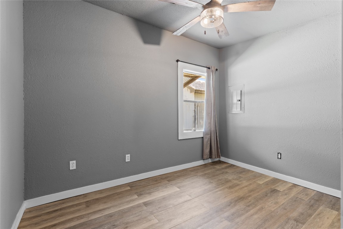 1910 Stringtown Road Shepherd, TX 77371 - Photo 13 of 24 an empty room with chandelier fan and windows