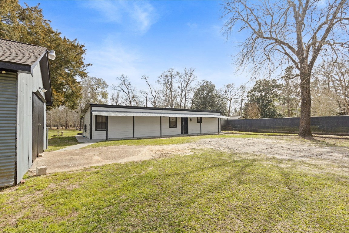 1910 Stringtown Road Shepherd, TX 77371 - Photo 2 of 24 a view of a yard in front of a house with large trees