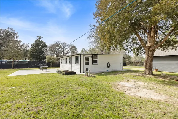 a view of a house with pool and a yard