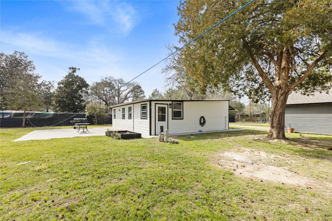 1910 Stringtown Road Shepherd, TX 77371 - Photo 21 of 24 a view of a house with pool and a yard