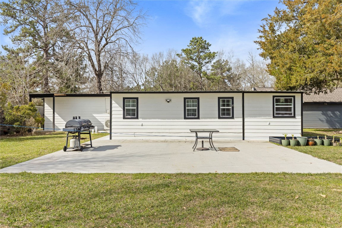 1910 Stringtown Road Shepherd, TX 77371 - Photo 22 of 24 a view of a house with backyard and a tree