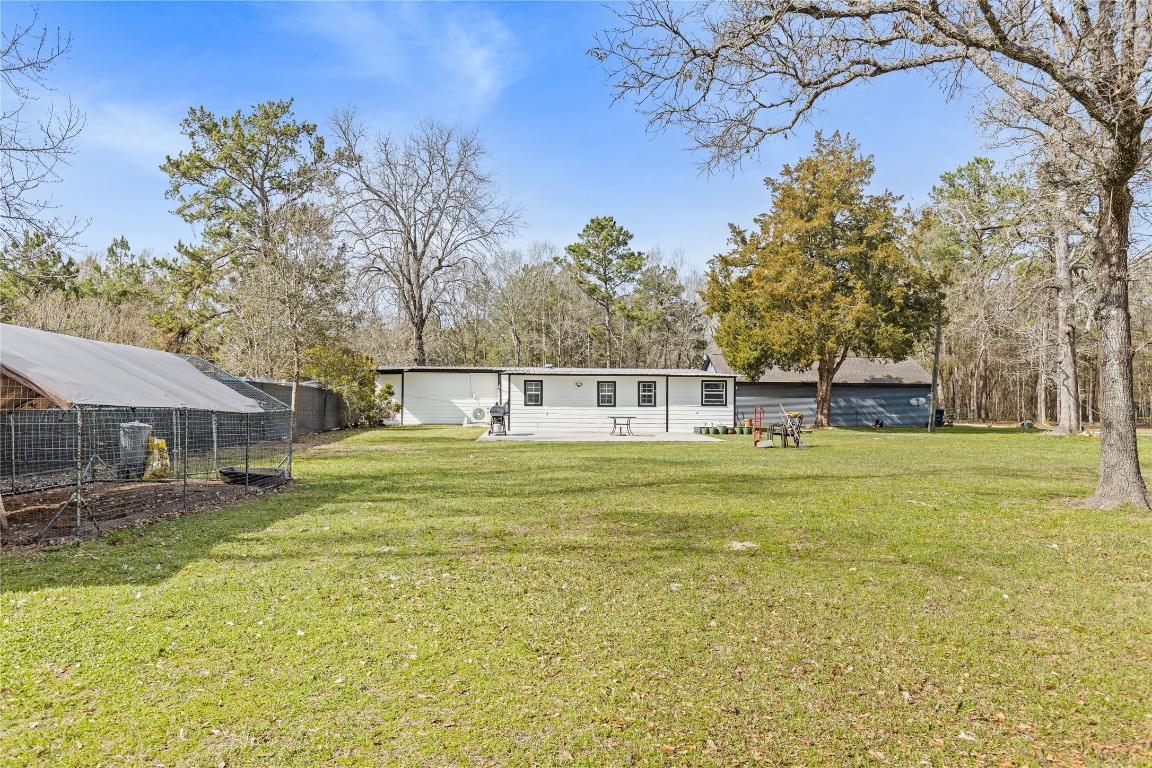 1910 Stringtown Road Shepherd, TX 77371 - Photo 23 of 24 a front view of a house with a big yard