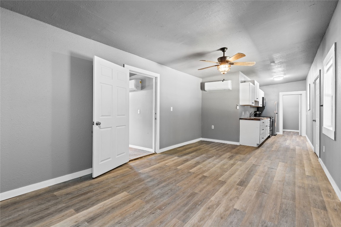1910 Stringtown Road Shepherd, TX 77371 - Photo 4 of 24 a view of a kitchen with wooden floor and a ceiling fan