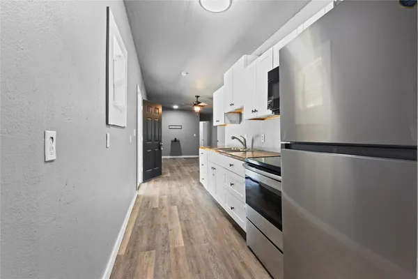 a kitchen with stainless steel appliances granite countertop a refrigerator and a stove