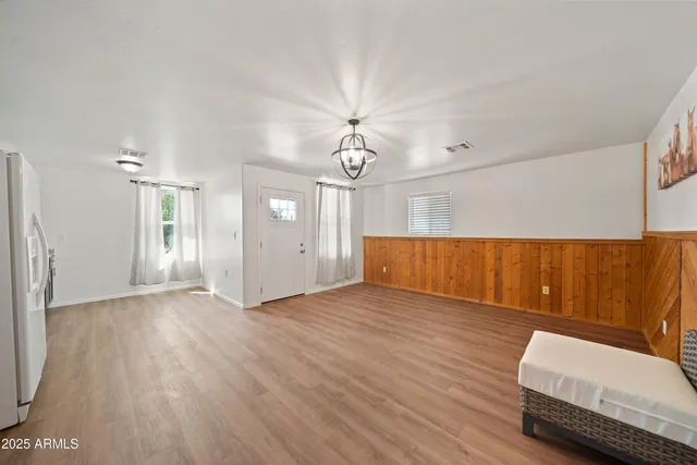 a view of room with furniture and wooden floor