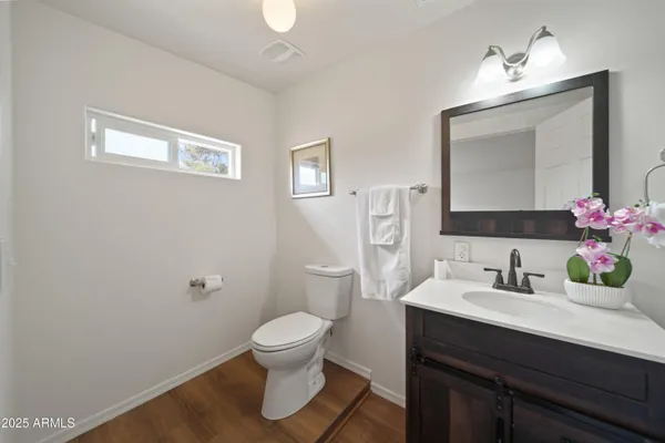 a bathroom with a sink toilet and mirror
