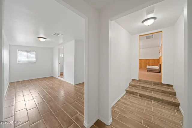 a view of an empty room and wooden floor