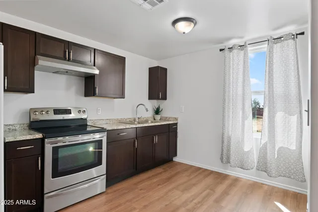 a kitchen with stainless steel appliances a stove and a sink