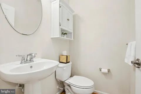 a bathroom with a sink a mirror and a toilet