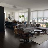 a living room with furniture window and wooden floor