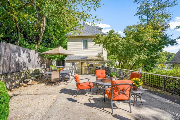 an outdoor sitting area with furniture and wooden fence