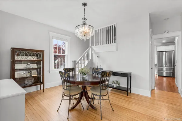 a view of a dining room with furniture wooden floor and chandelier