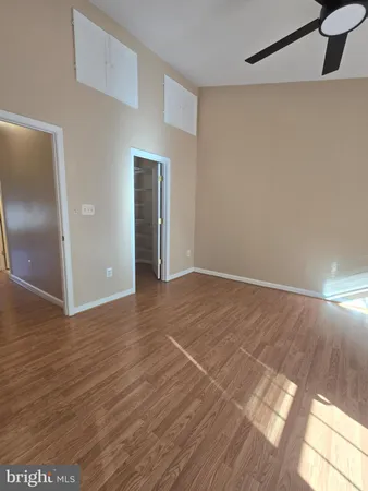 a view of an empty room with wooden floor