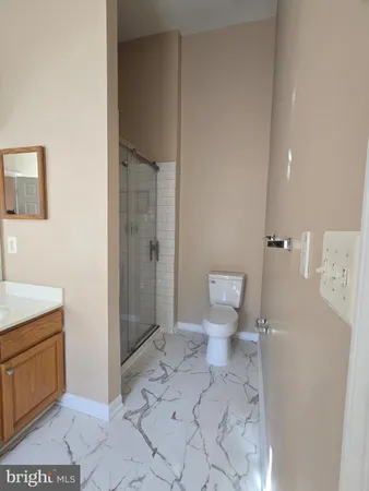 a bathroom with a toilet and a shower