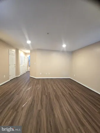 a view of an empty room and wooden floor