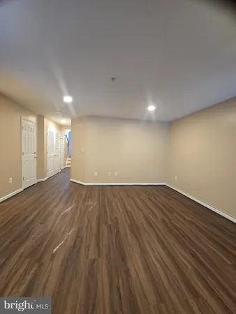 a view of an empty room and wooden floor