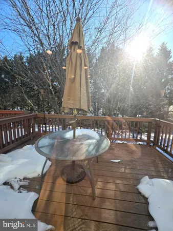 a view of a porch with a table and chairs