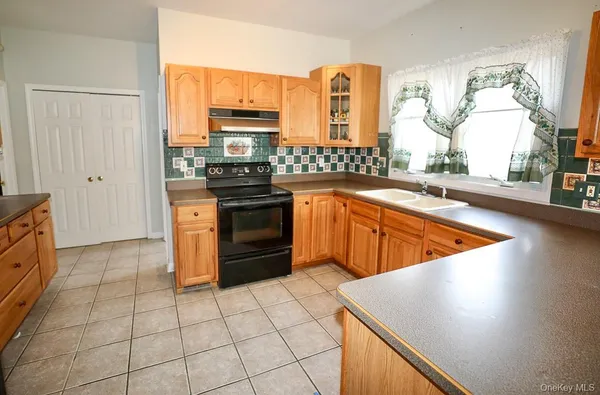 a kitchen with stainless steel appliances granite countertop a sink counter space and cabinets