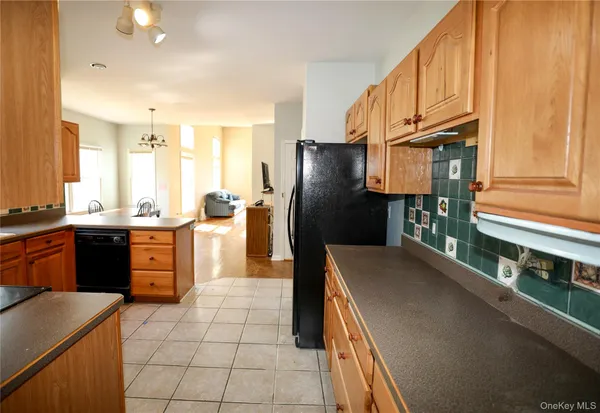 a kitchen with stainless steel appliances granite countertop a refrigerator a sink a stove and island