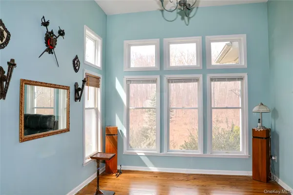 a view of a room with wooden floor and windows