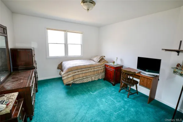 a bedroom with bed and tv