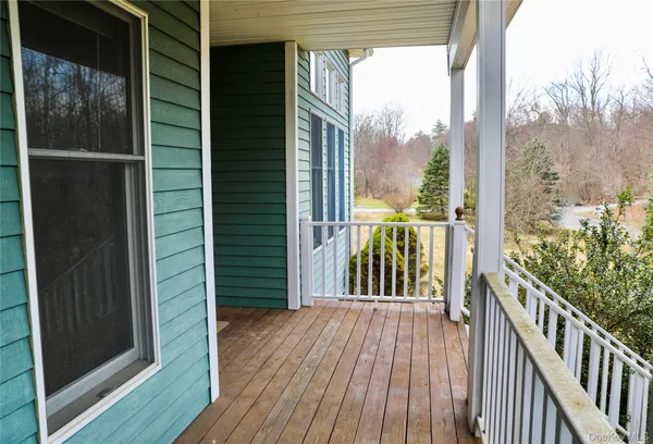 a view of a balcony with wooden floor