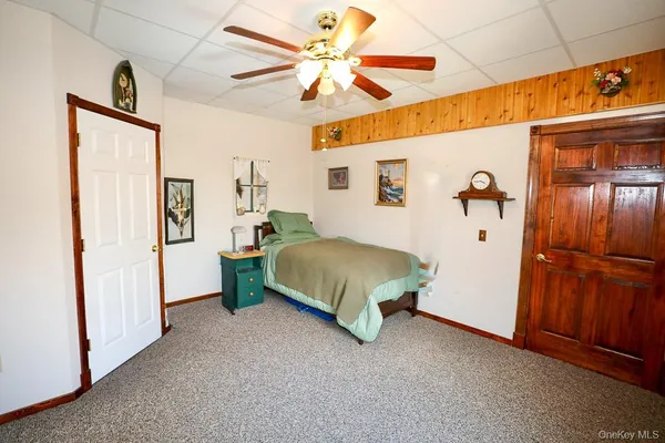 a spacious bedroom with a bed and a chandelier