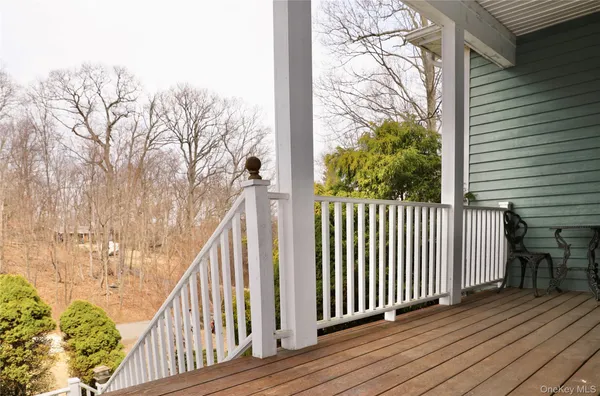 a view of a wooden balcony with wooden floor and fence
