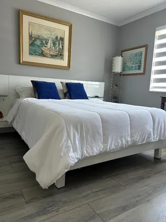 a bedroom with bed and wooden floor