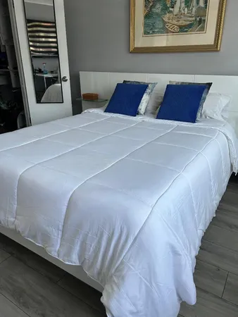 a bedroom with bed and wooden floor