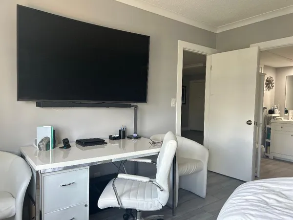 a view of a livingroom with furniture and a flat screen tv