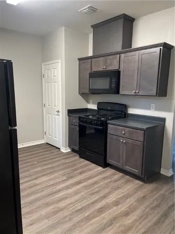 a kitchen with stainless steel appliances granite countertop a stove and a microwave