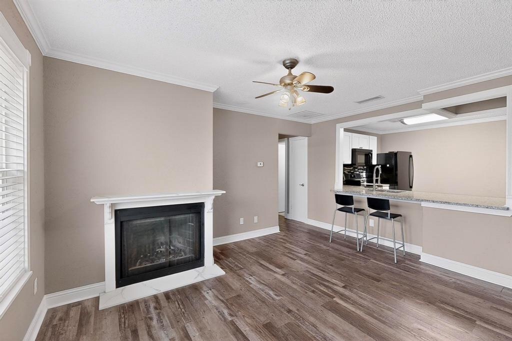 2200 East Trinity Mills Road, Unit 616 Carrollton, TX 75006 - Photo 1 of 25 a living room with furniture and a fireplace
