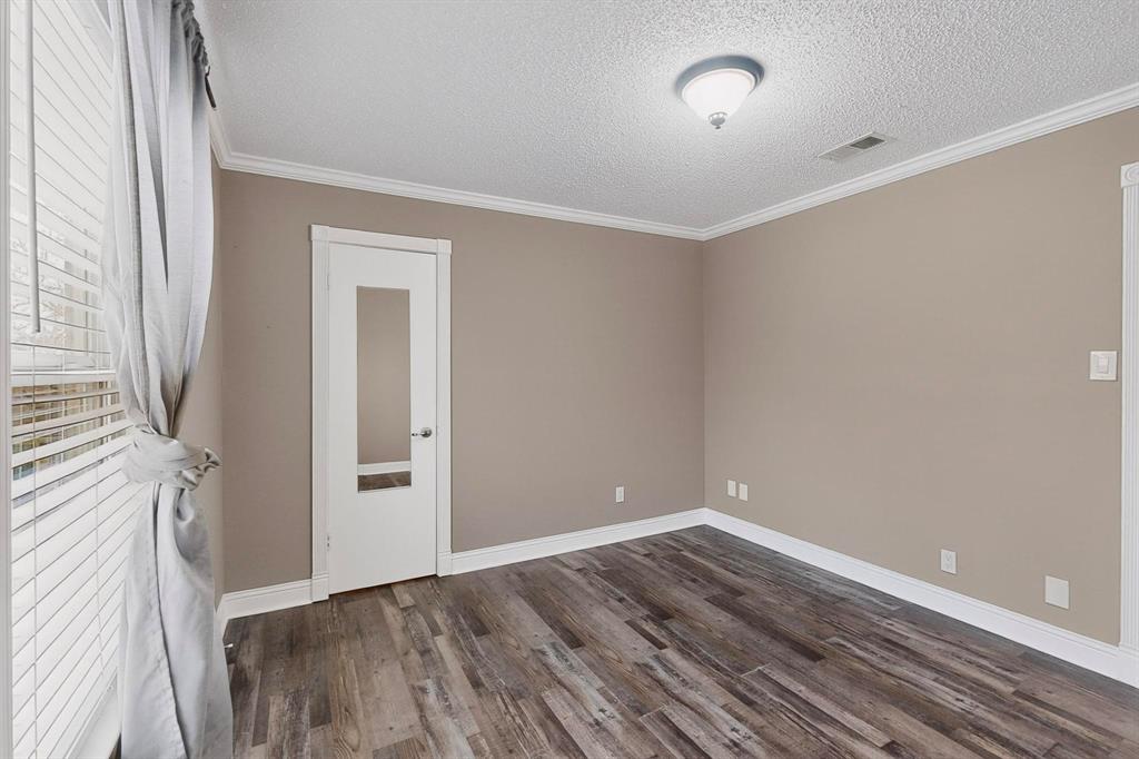2200 East Trinity Mills Road, Unit 616 Carrollton, TX 75006 - Photo 14 of 25 a view of room with window and wooden floor