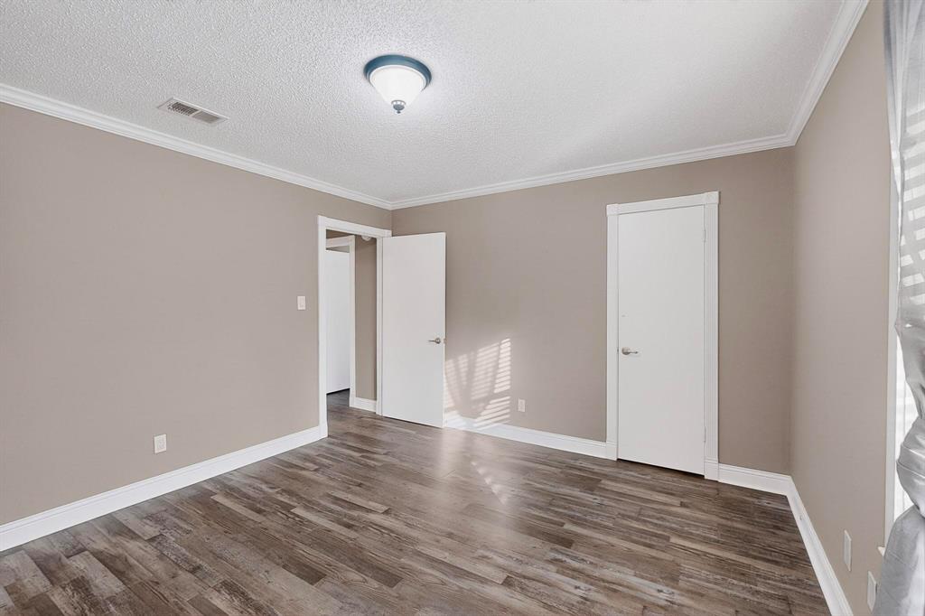 2200 East Trinity Mills Road, Unit 616 Carrollton, TX 75006 - Photo 15 of 25 a view of an empty room with wooden floor