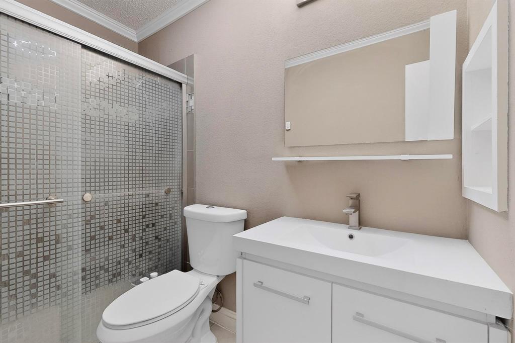 2200 East Trinity Mills Road, Unit 616 Carrollton, TX 75006 - Photo 17 of 25 a bathroom with a sink a toilet and a mirror