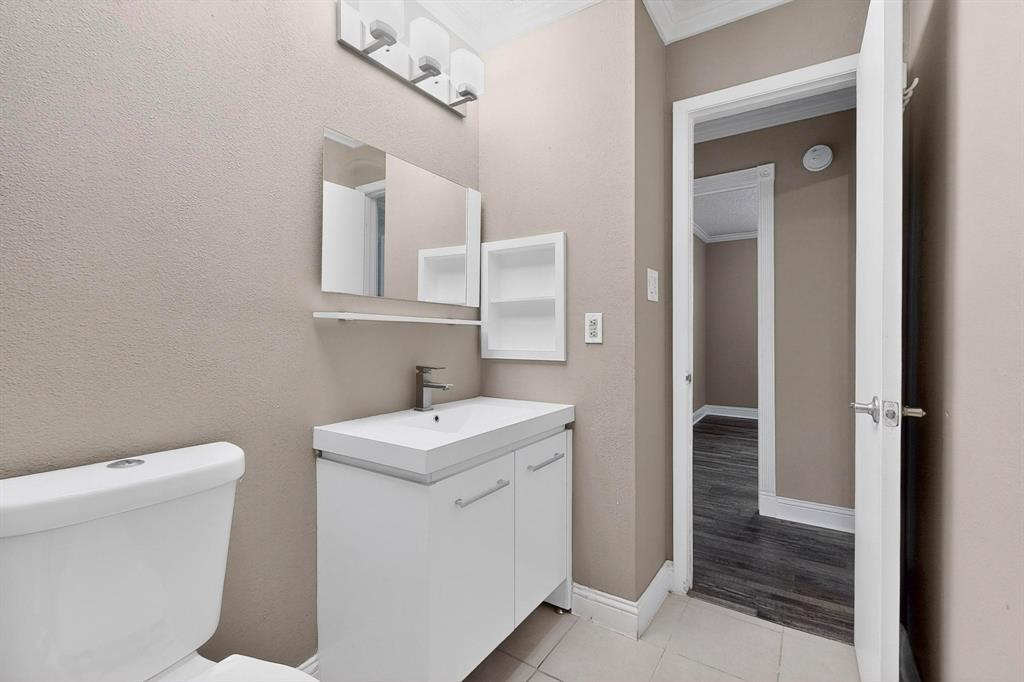 2200 East Trinity Mills Road, Unit 616 Carrollton, TX 75006 - Photo 19 of 25 a bathroom with a toilet sink and mirror