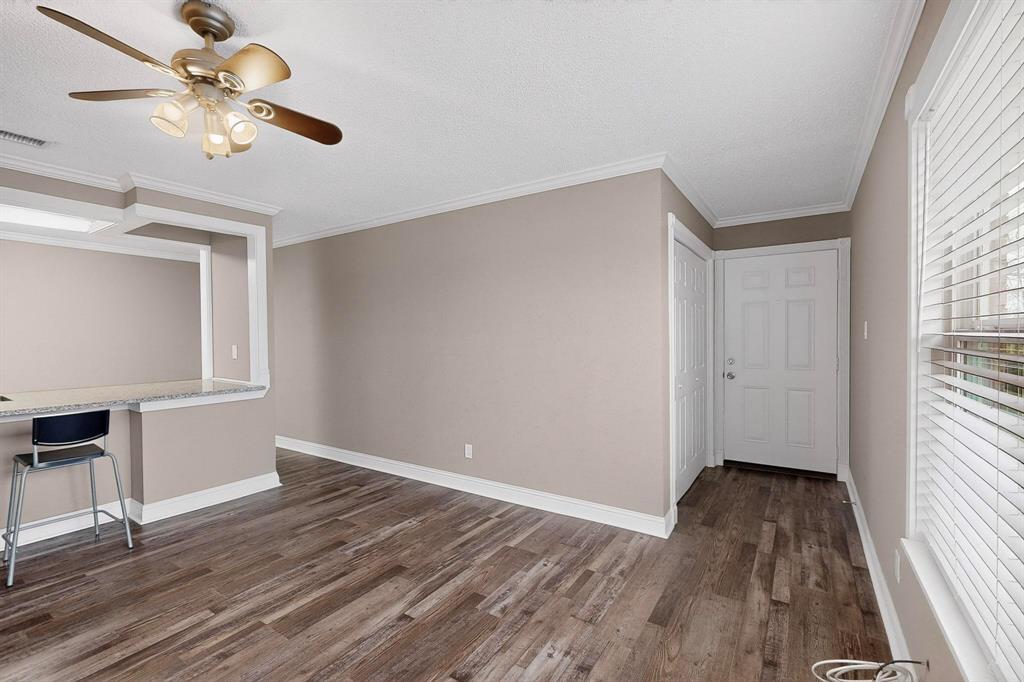 2200 East Trinity Mills Road, Unit 616 Carrollton, TX 75006 - Photo 2 of 25 wooden floor in an empty room with a window