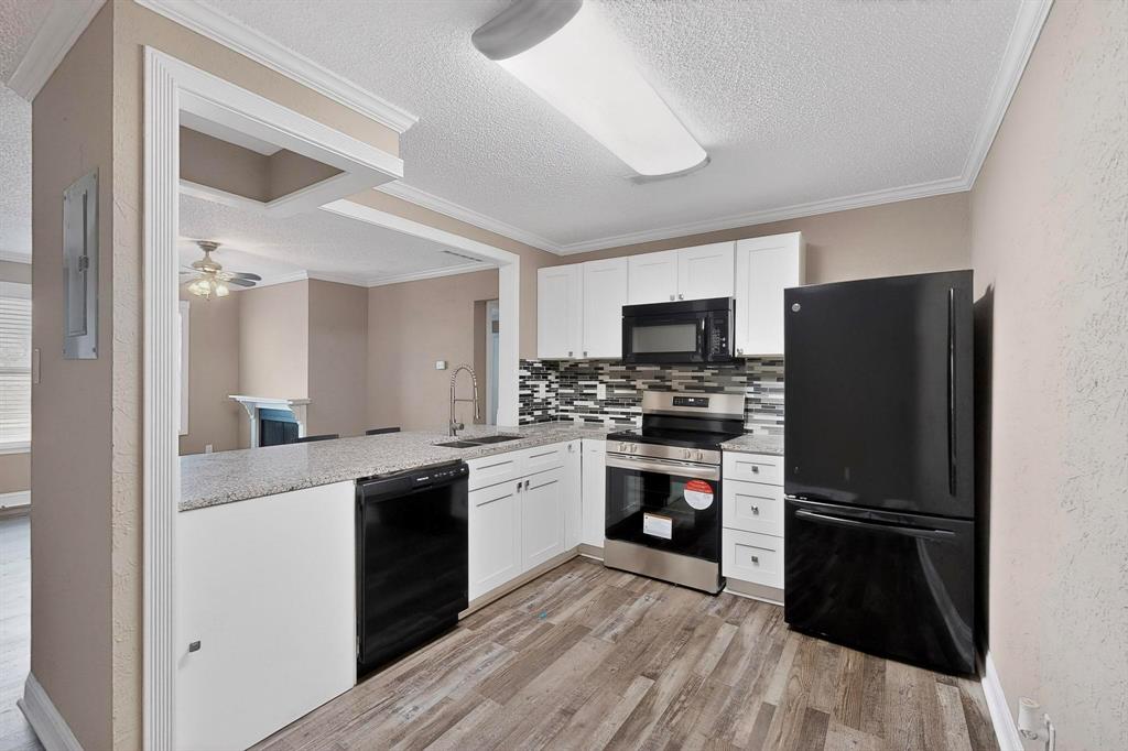 2200 East Trinity Mills Road, Unit 616 Carrollton, TX 75006 - Photo 5 of 25 a kitchen with a refrigerator stove and sink
