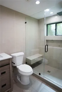 a white toilet sitting next to a bathroom sink