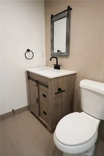 a bathroom with a toilet a sink and mirror